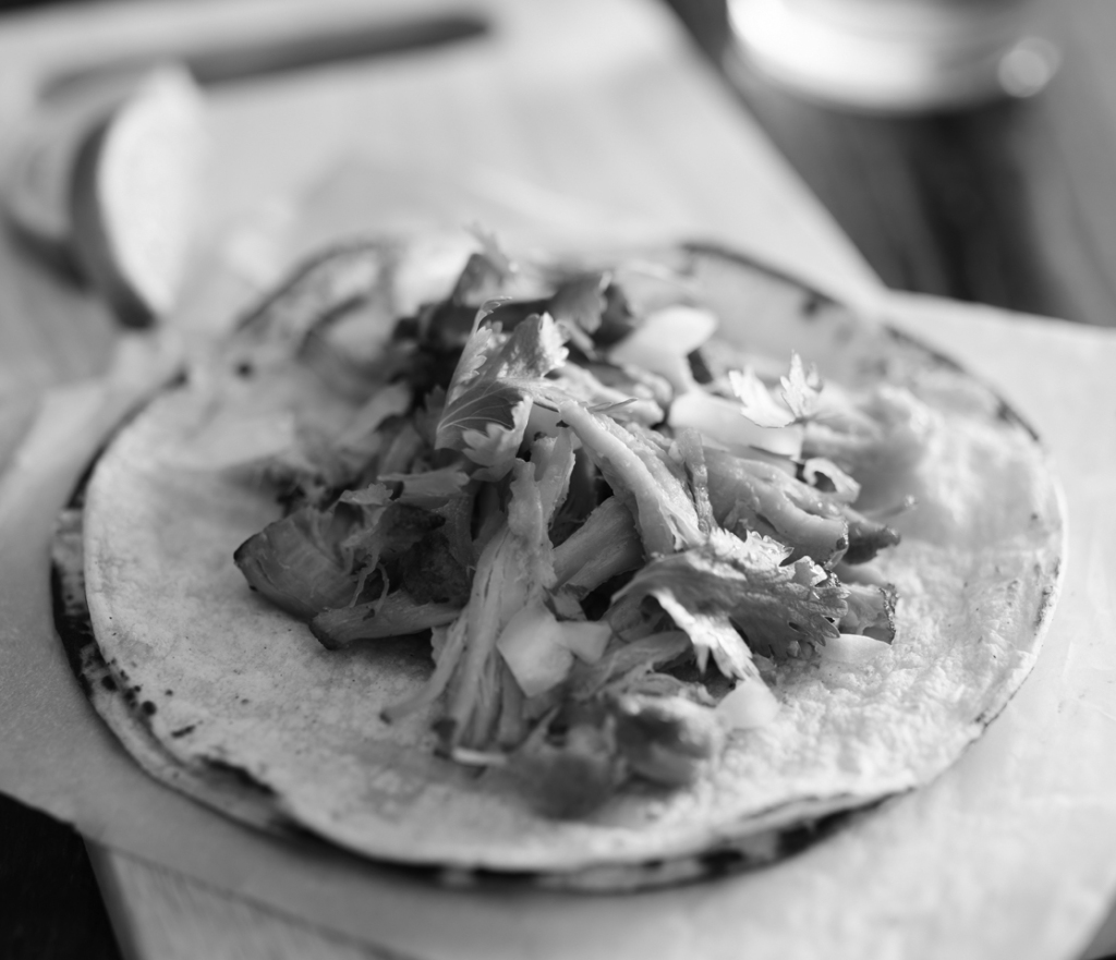 authentic mexican tacos with carnitas, cilantro and onion